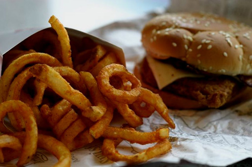 A fast food sandwich with curly fries