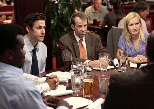 Office characters sitting at a restaurant table